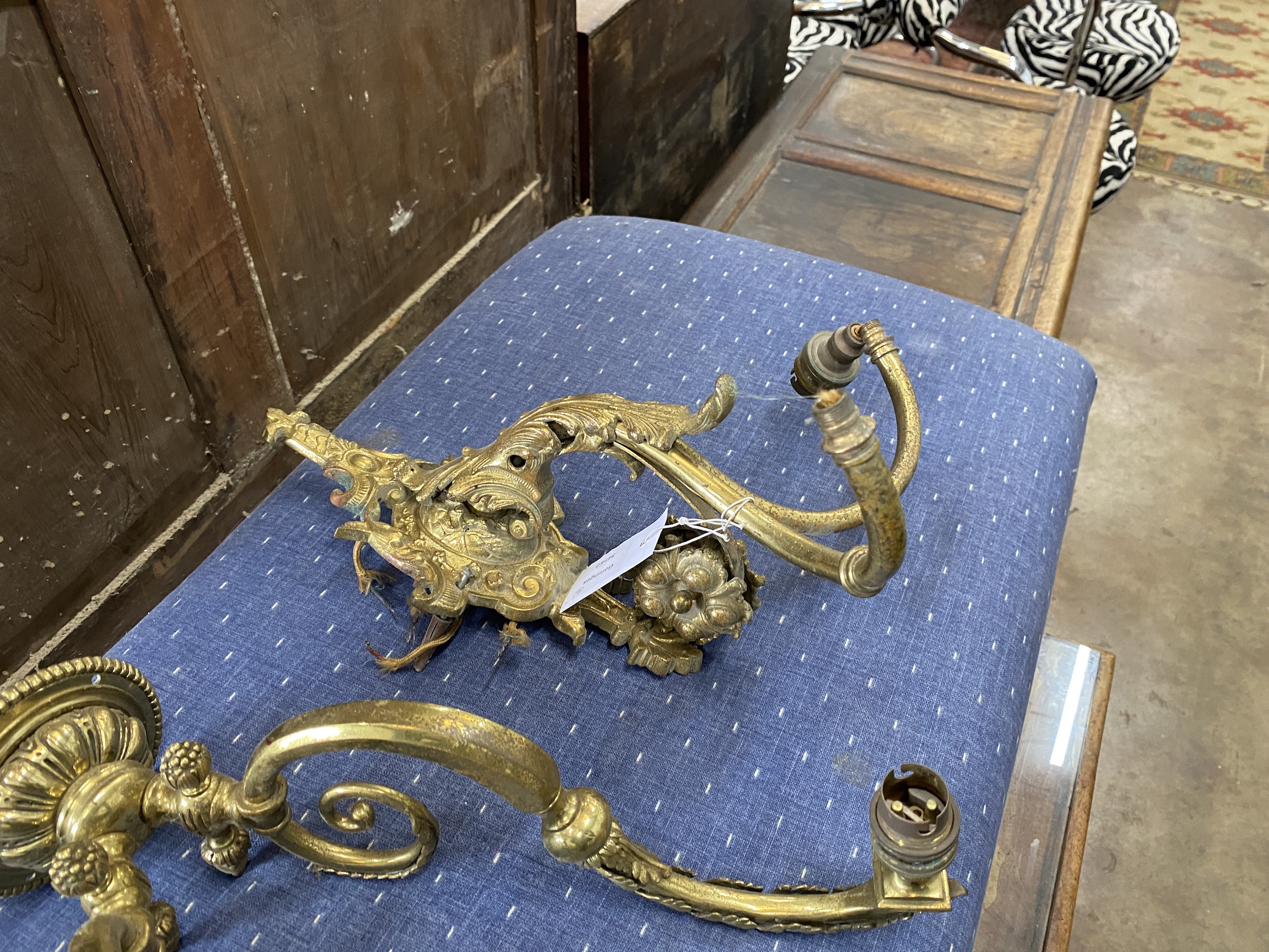 Three gilt metal wall lights, largest height 46cm